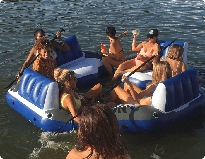 A group of people in the water on inflatable rafts.