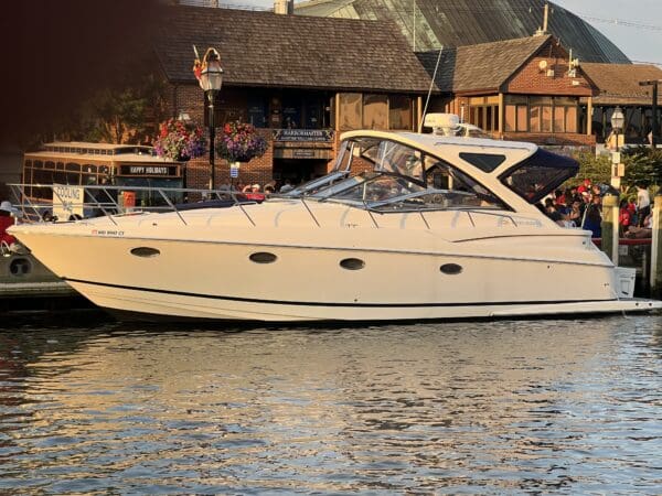 A boat is parked in the water near some buildings.