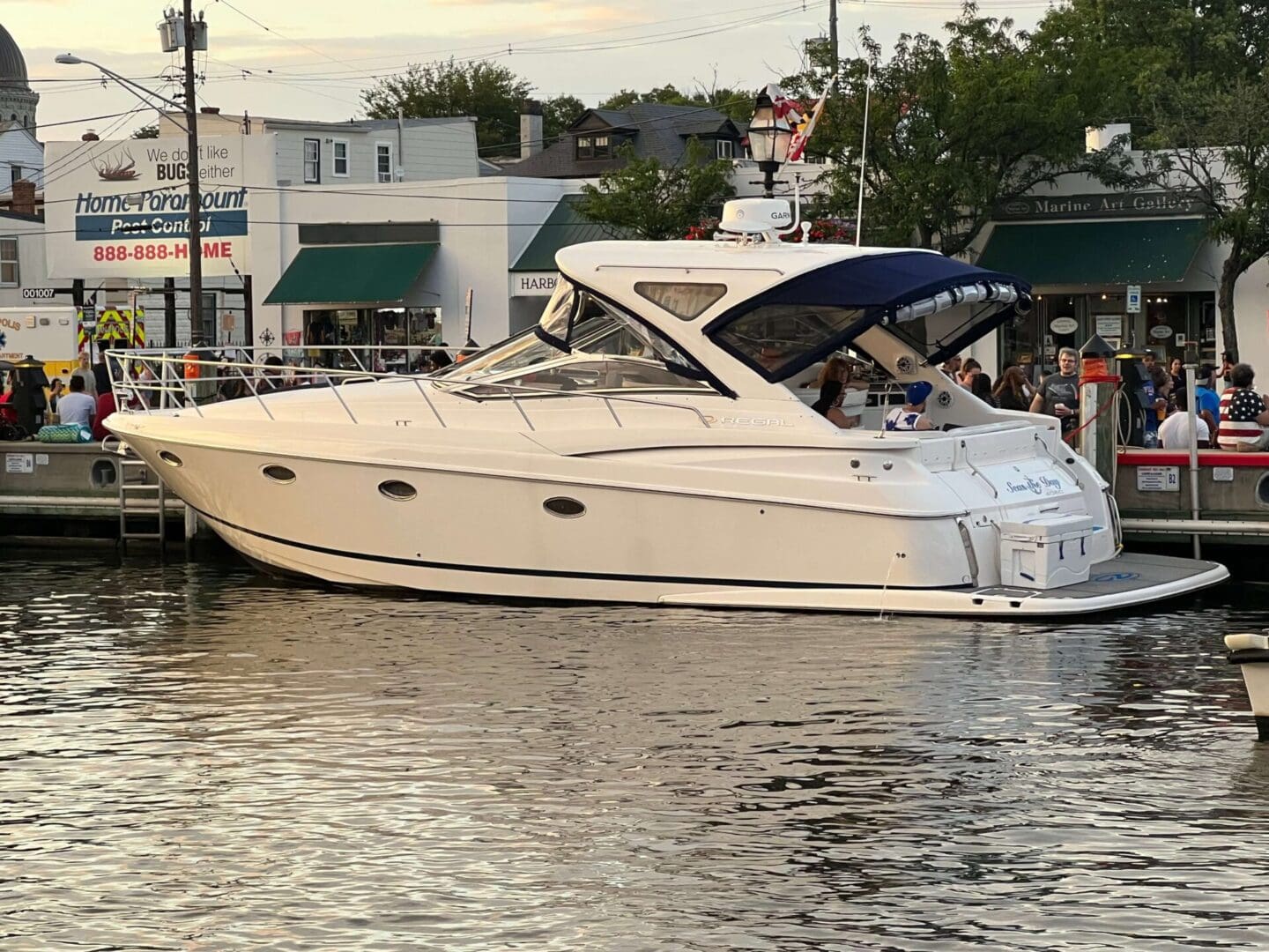 A boat is docked in the water near some buildings.